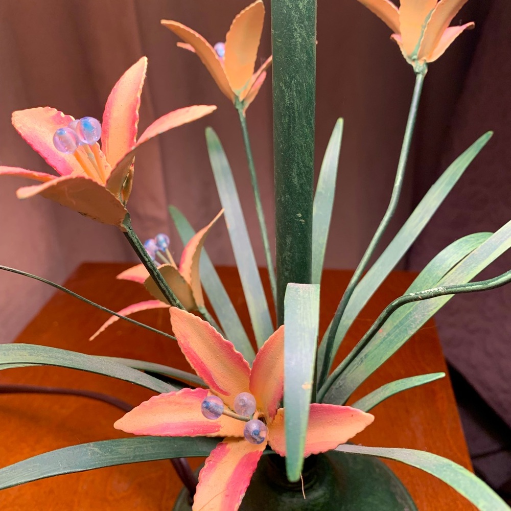 Vintage Toleware lamp with orange Lillie’s and green leaves.
